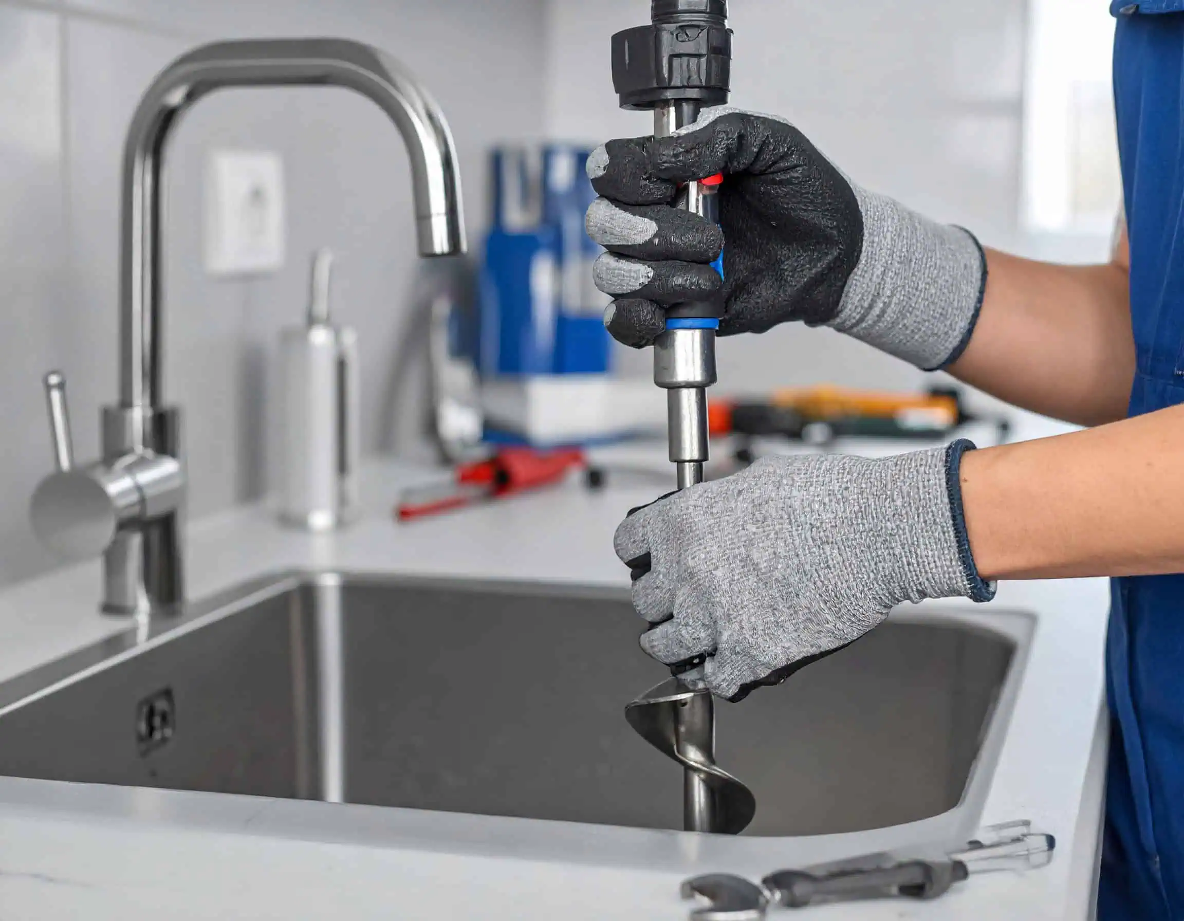 Plumber-Snake-Draining-Clogged-Kitchen-Sink-Drain